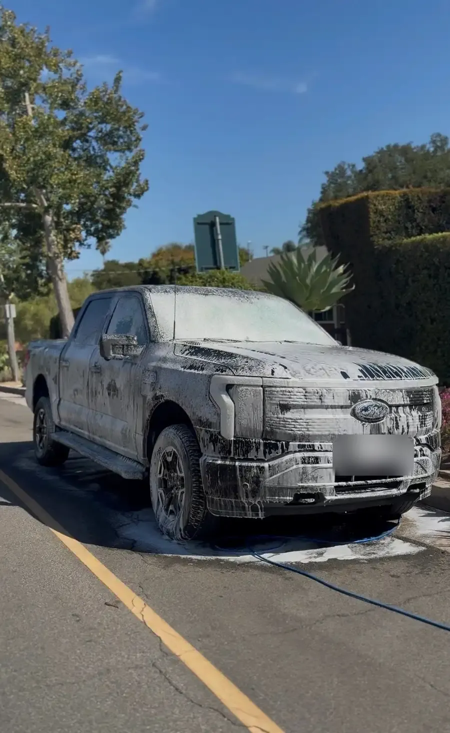 Pickup truck covered in foam during a mobile wash