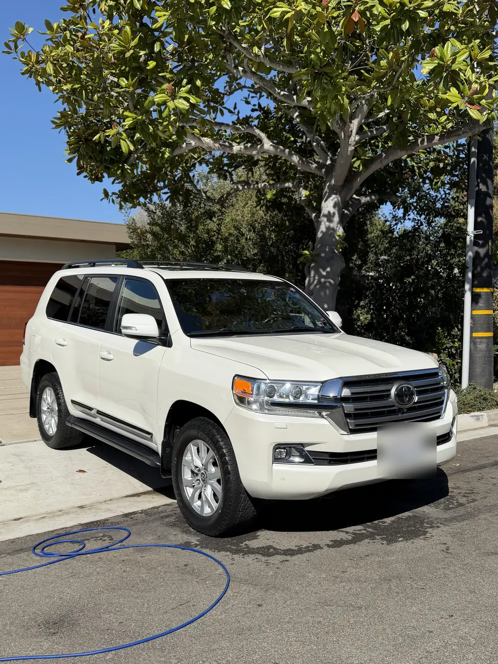 White Toyota Land Cruiser, washed in a driveway